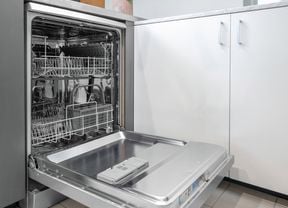 A dishwasher with the door open in a kitchen.