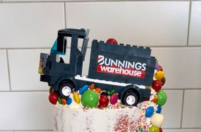 birthday sponge cake been decorated with white icing and Bunnings forklift as the topper on the cake