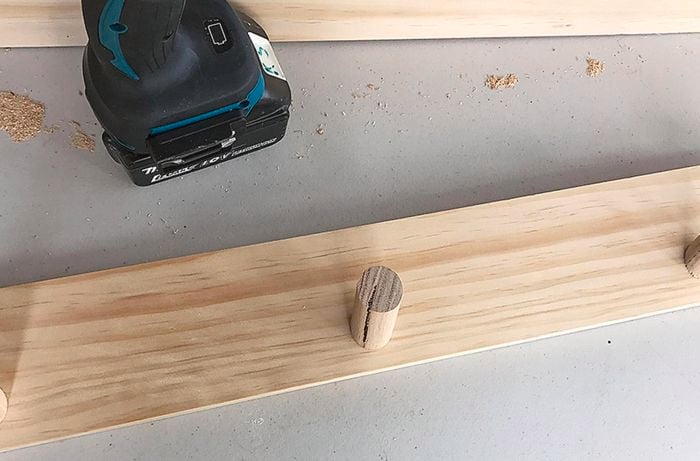 A backing board being attached to a coat rack