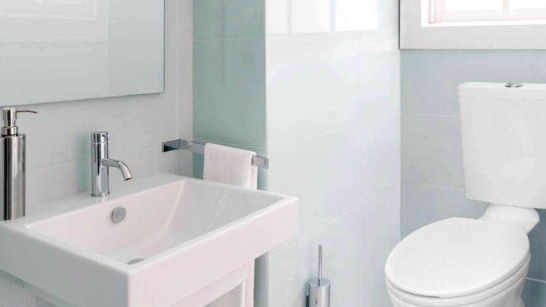Spotless and clean toilet and sink in a modern bathroom.