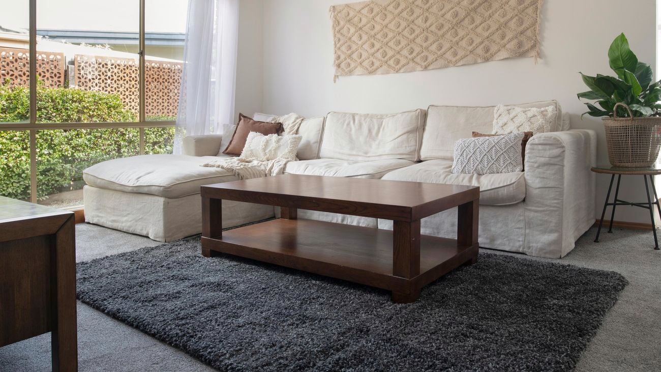 Dark grey textured rug in a living room.