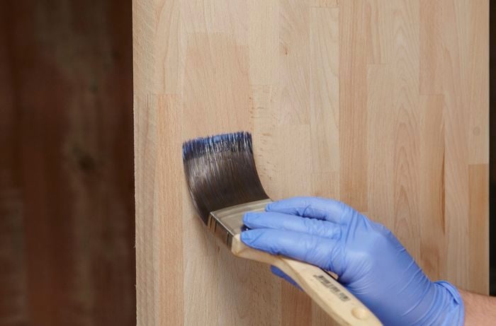 Person varnishing piece of timber.