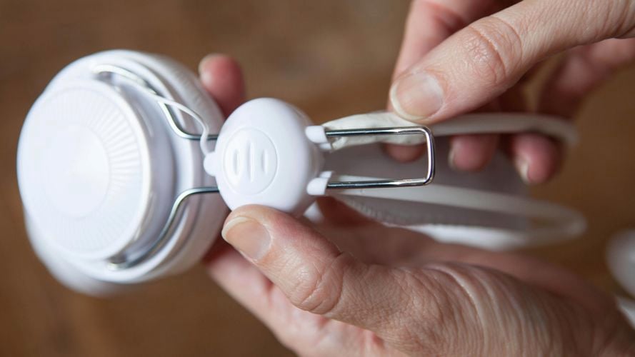 A person repairing a headphone.