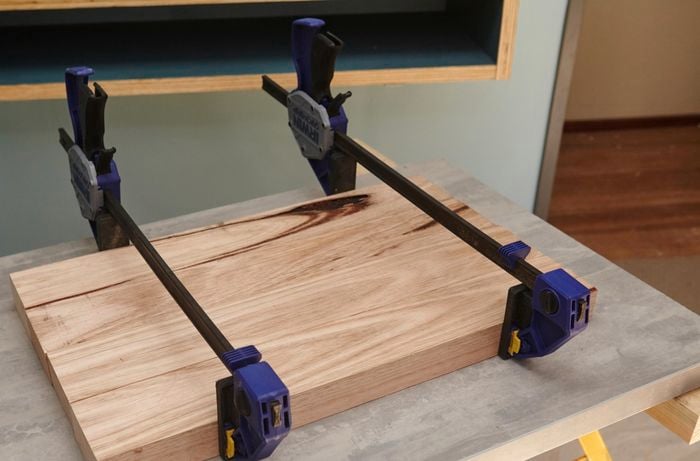 Four lengths of timber held together with clamps