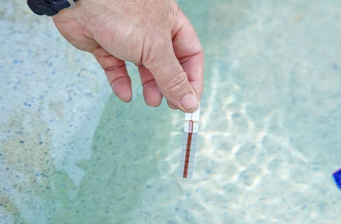 Testing the salt content of a pool using a salt test strip kit