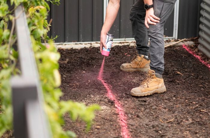 Marking the pathway with spray paint.