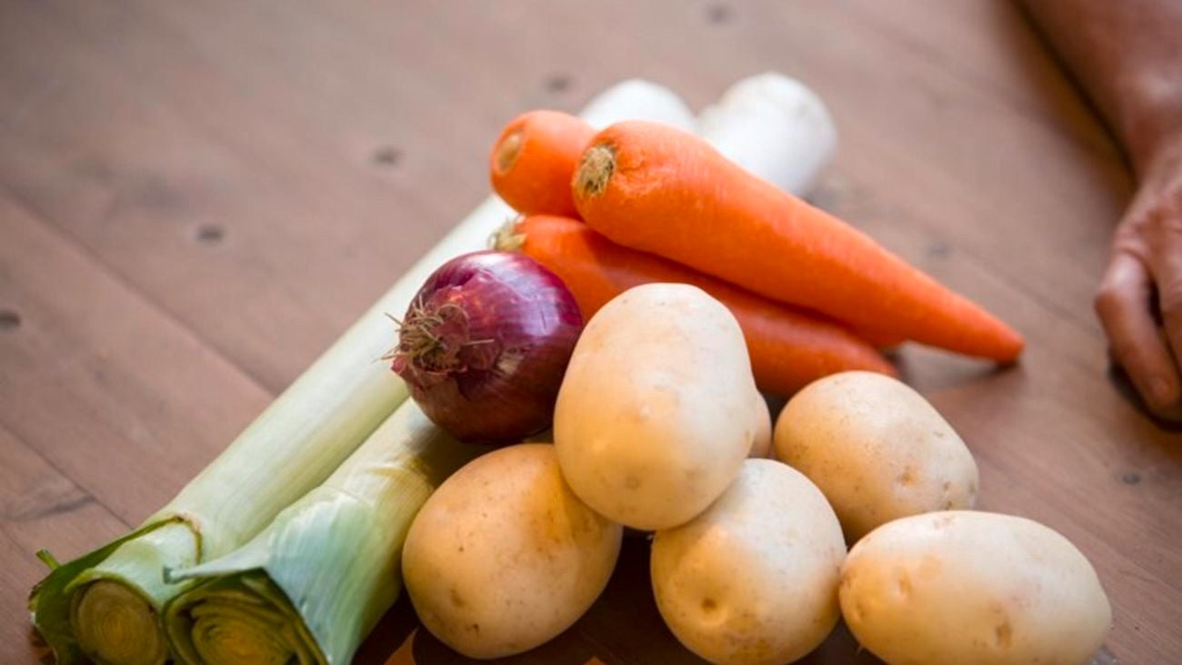 Harvested vegetables including leeks, carrots and potatoes.