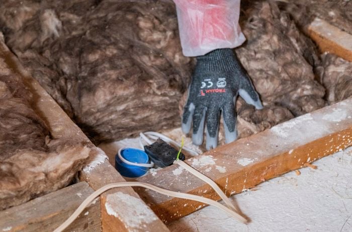 Space around a light fixture being kept clear of insulation