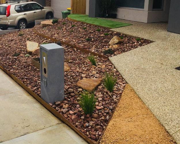 Front yard of home with pebble and stone garden