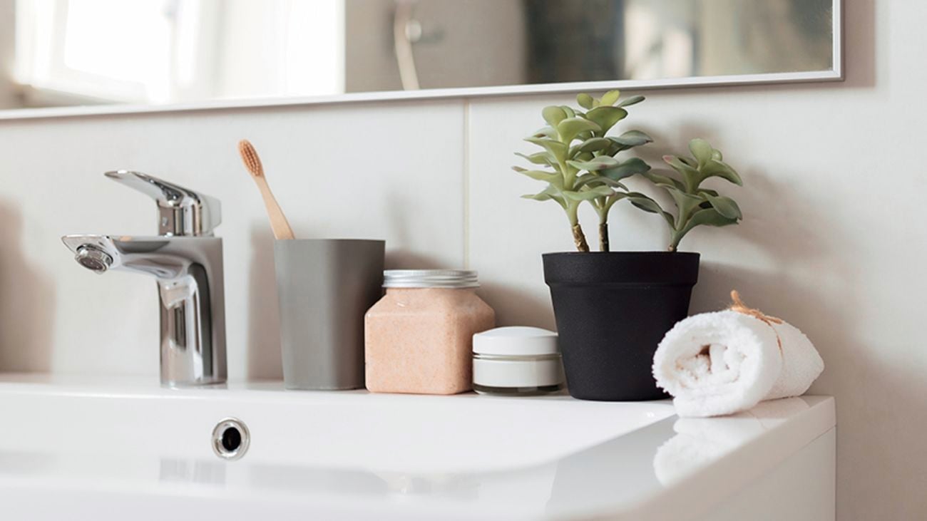 Bathroom products sit on top of a sink.