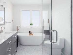 A modern white and grey bathroom with a curved freestanding bath and large stone-topped vanity