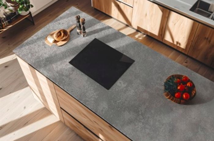 A silica-free stone benchtop with cooktop and fruit bowl.