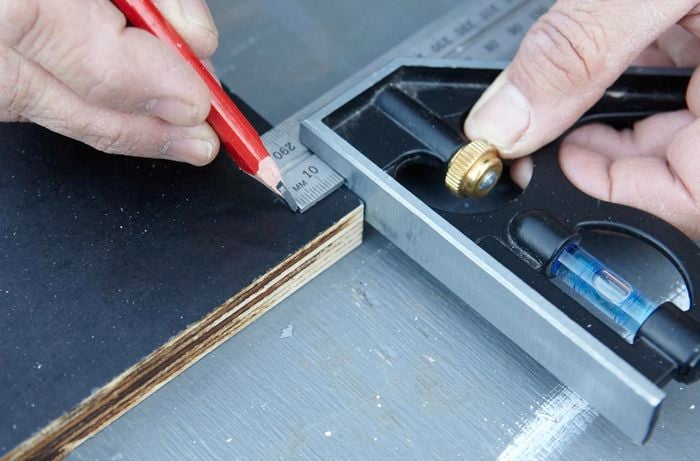A Square rule being used to mark drill points on a vertical garden tier