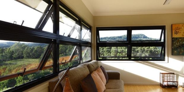 Living room with black framed push out windows.