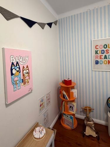 Kids bedroom with a Bluey painting on the wall