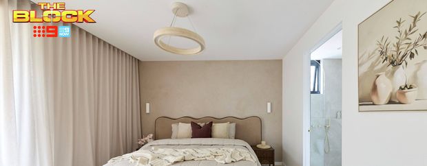 Neutral bedroom featuring a timber bed with soft beige bedding, floor-to-ceiling curtains, pendant light and adjoining ensuite.