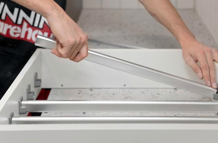 Fitting pieces of railing into a drawer.
