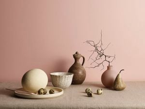 Pink wall and table with assorted table decorations