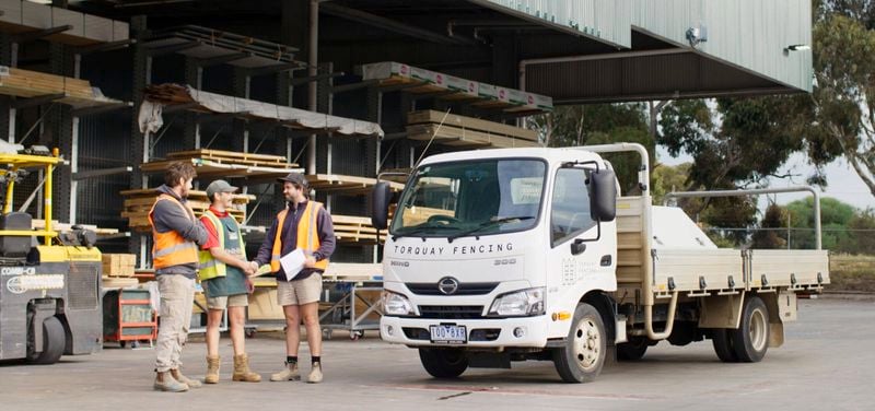 bunnings team member shaking hands with a customer in the timber yard