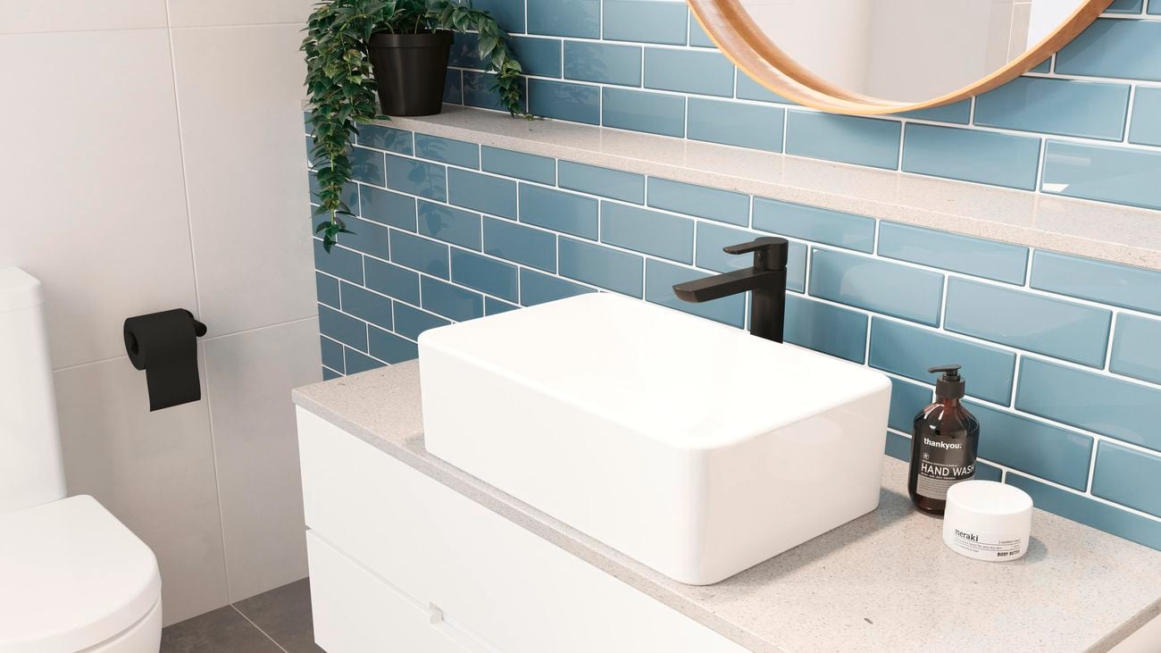Blue tiled bathroom featuring a Caroma ‘Jade’ basin mixer and white basin