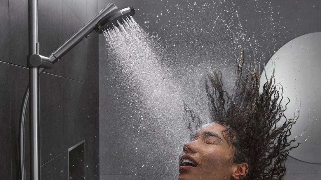 Girl washing her hair in the shower.