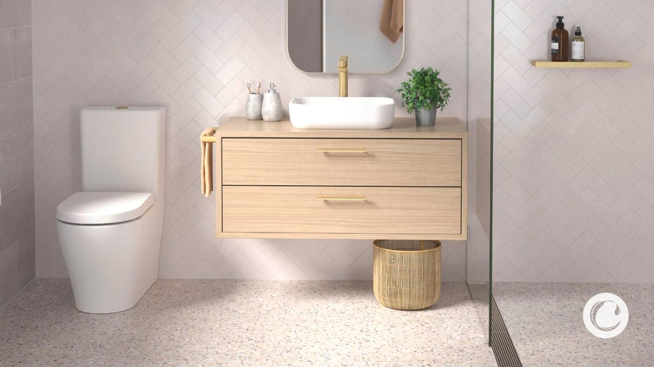 A bathroom with a sink on top of a wooden cabinet, a mirror on the wall and a toilet