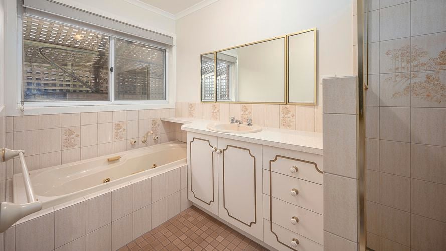 Old fashion bathroom with a bath, shower and basin in it