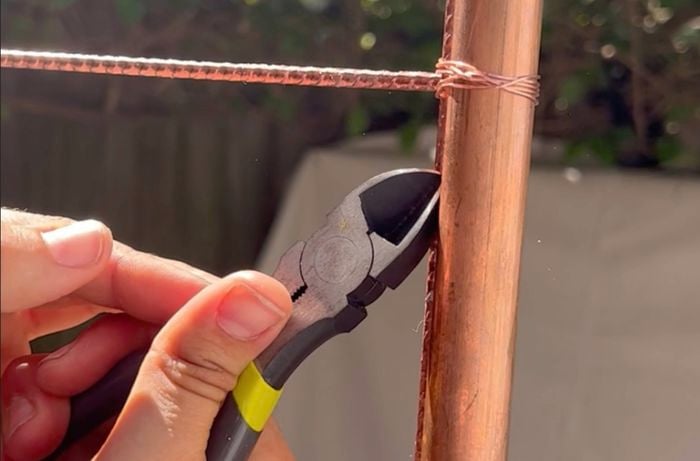 D.I.Y. photo booth frame size assembly – securing mesh with wire ties.