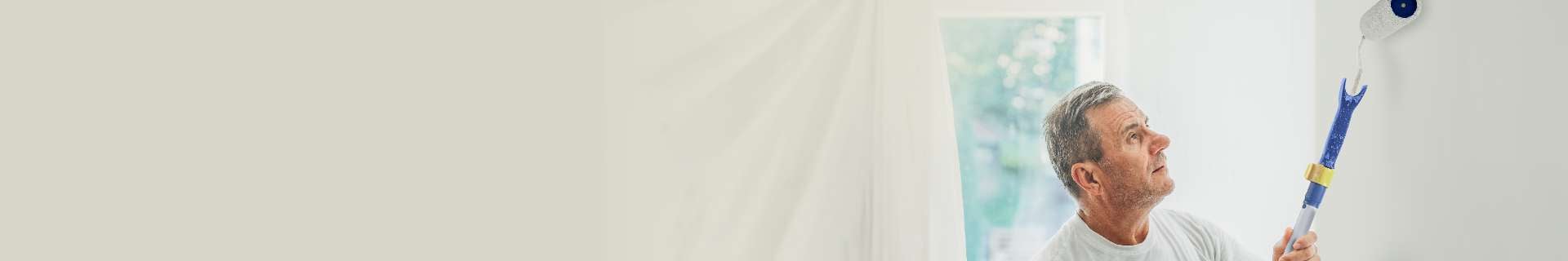 Man painting wall white