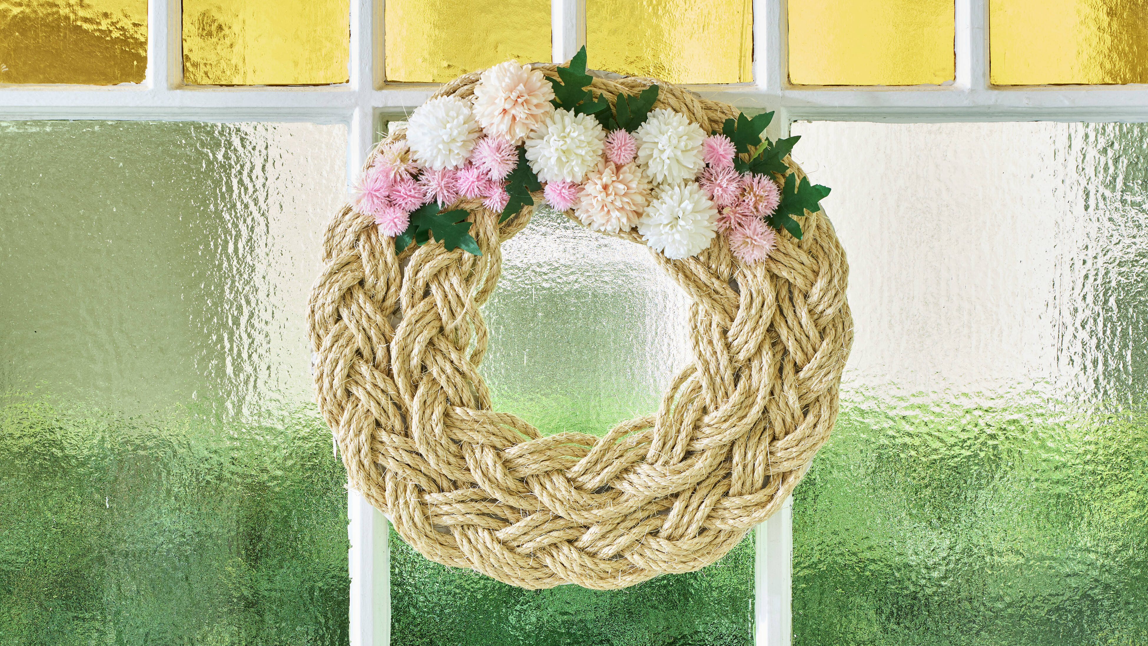 A decorative wreath on a stained-glass window pane