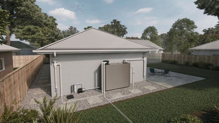 The backyard of a house attached by downpipe to a slimline water tank surrounded by fence and trees.