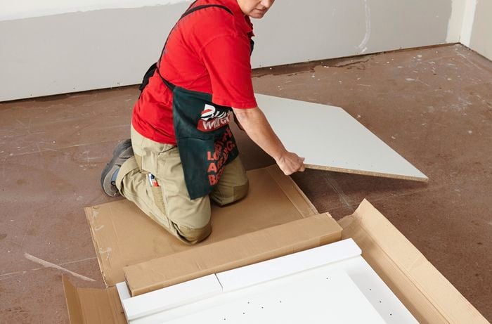 Person unpacking cabinet flat pack