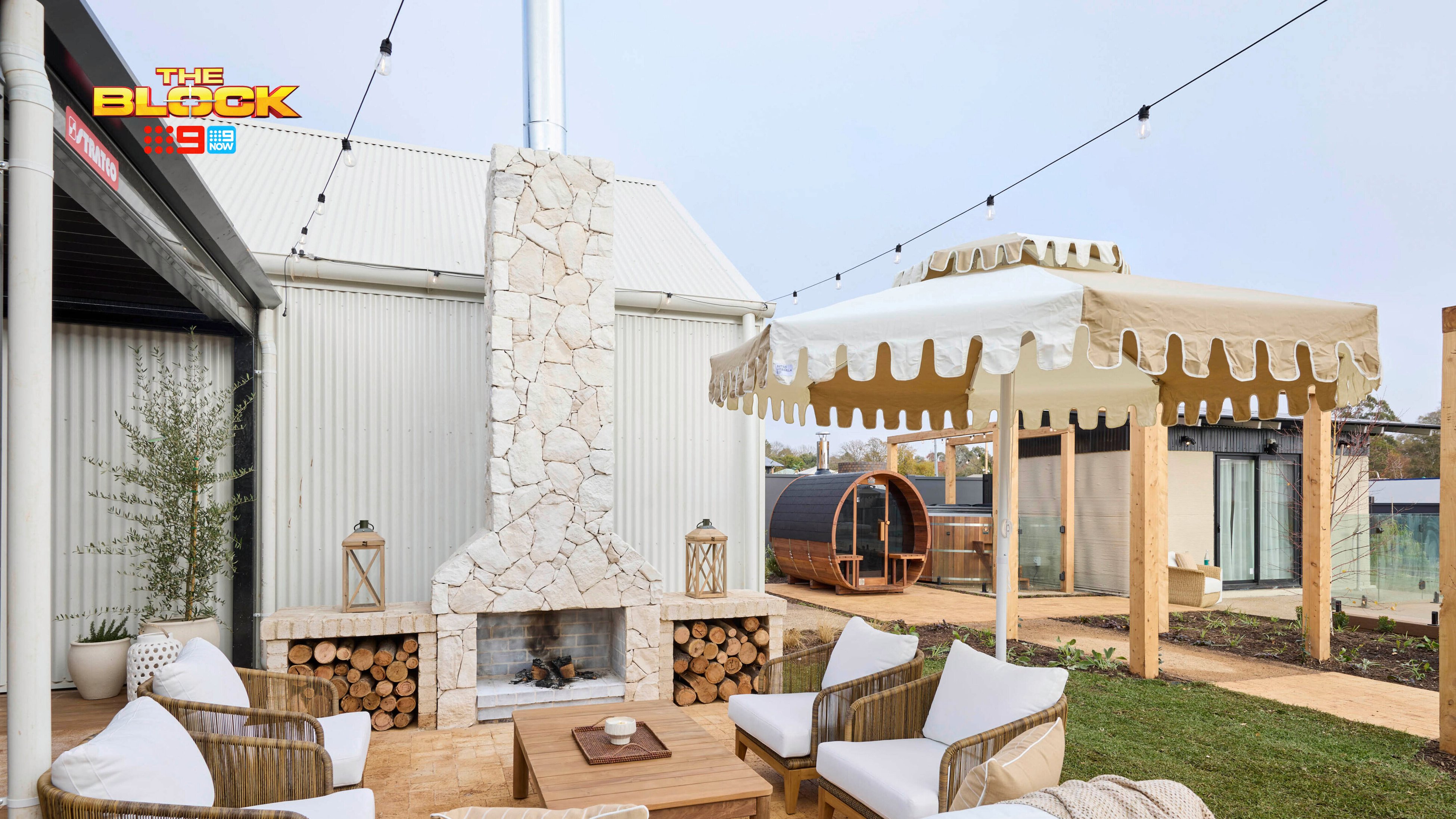 Outdoor area with an outdoor setting, outdoor fire place, gazebo and an outdoor room in it.