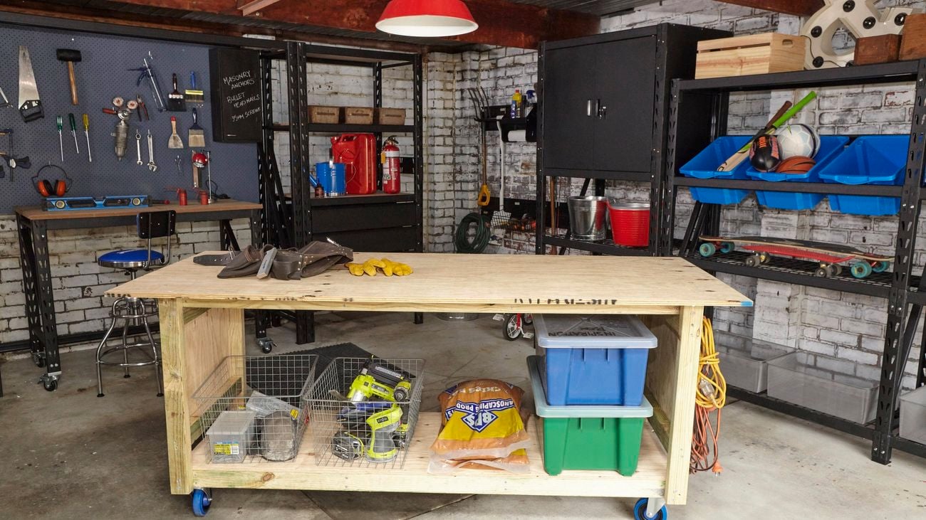 Workbench in a garage with tools and storage.