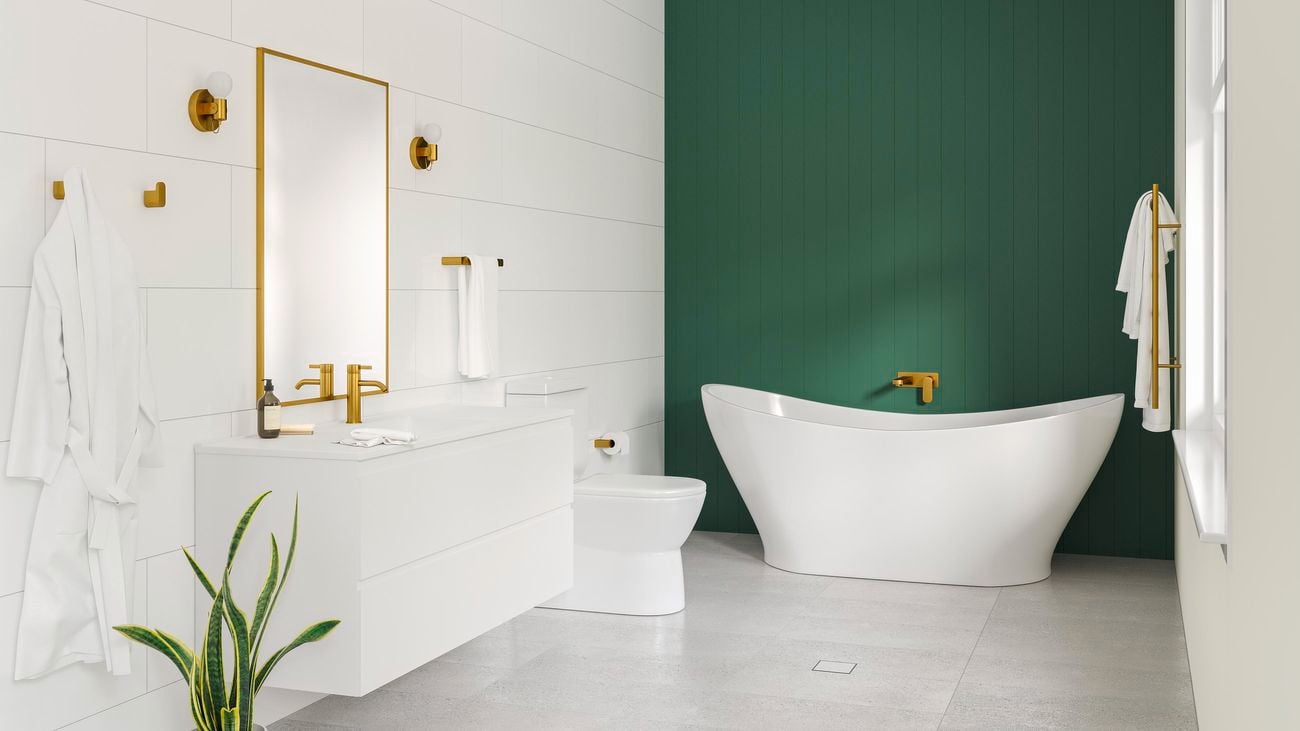 A HardieGroove VJ panelled feature wall painted in Dulux Highland Green behind a tub in a contemporary modern bathroom. The bathroom is styled with brushed brass tapware and accessories