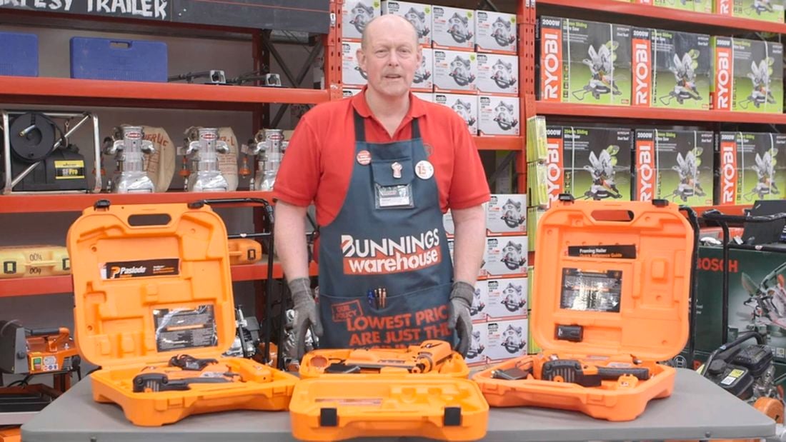 Bunnings team member standing behind three nailers on a table