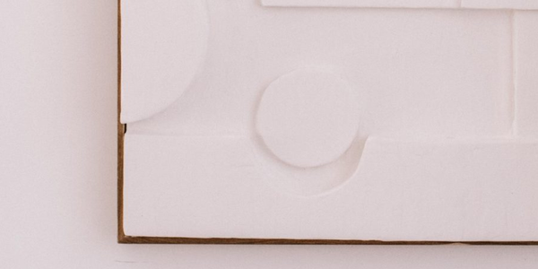 White artwork hung on wall