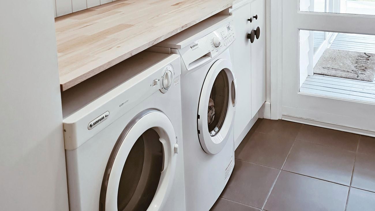 Laundry with timber shelves and washing machine, dryer.