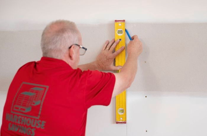 Mark the midline using a spirit level on the wall