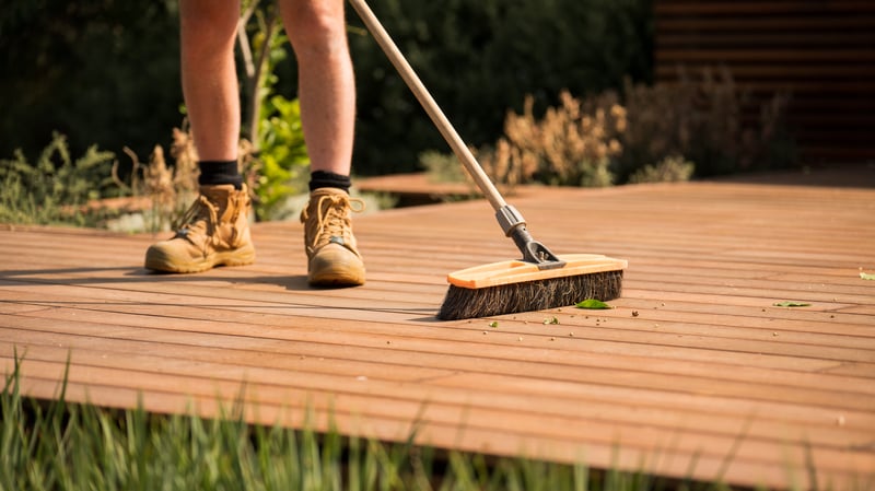 Person sweeping deck