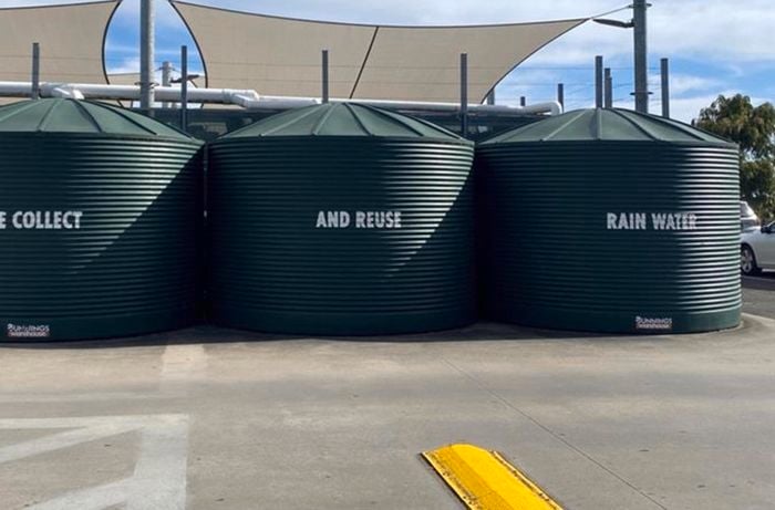three rain tanks on exterior of warehouse