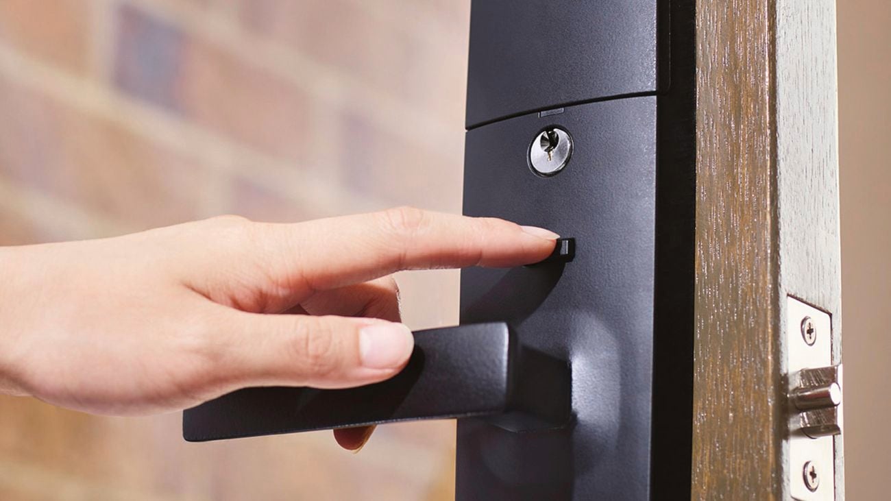 Person's hand presses a button on a black Gainsborough Freestyle Trilock.