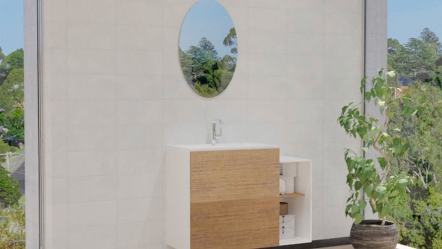 Bathroom with oval mirror along with wash basin, storage shelf and white wall tiles.