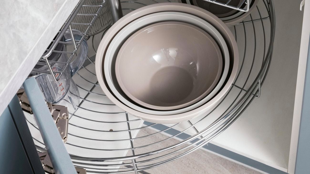 Rotating corner baskets in cabinet under benchtop