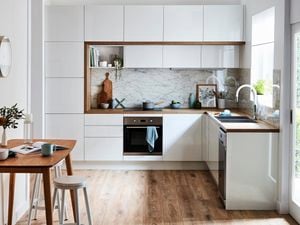 Scandi look kitchen with white cabinetry and wooden furnishings