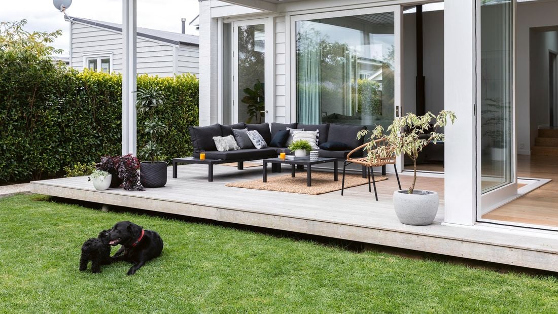 Outdoor alfresco area with black outdoor steel setting