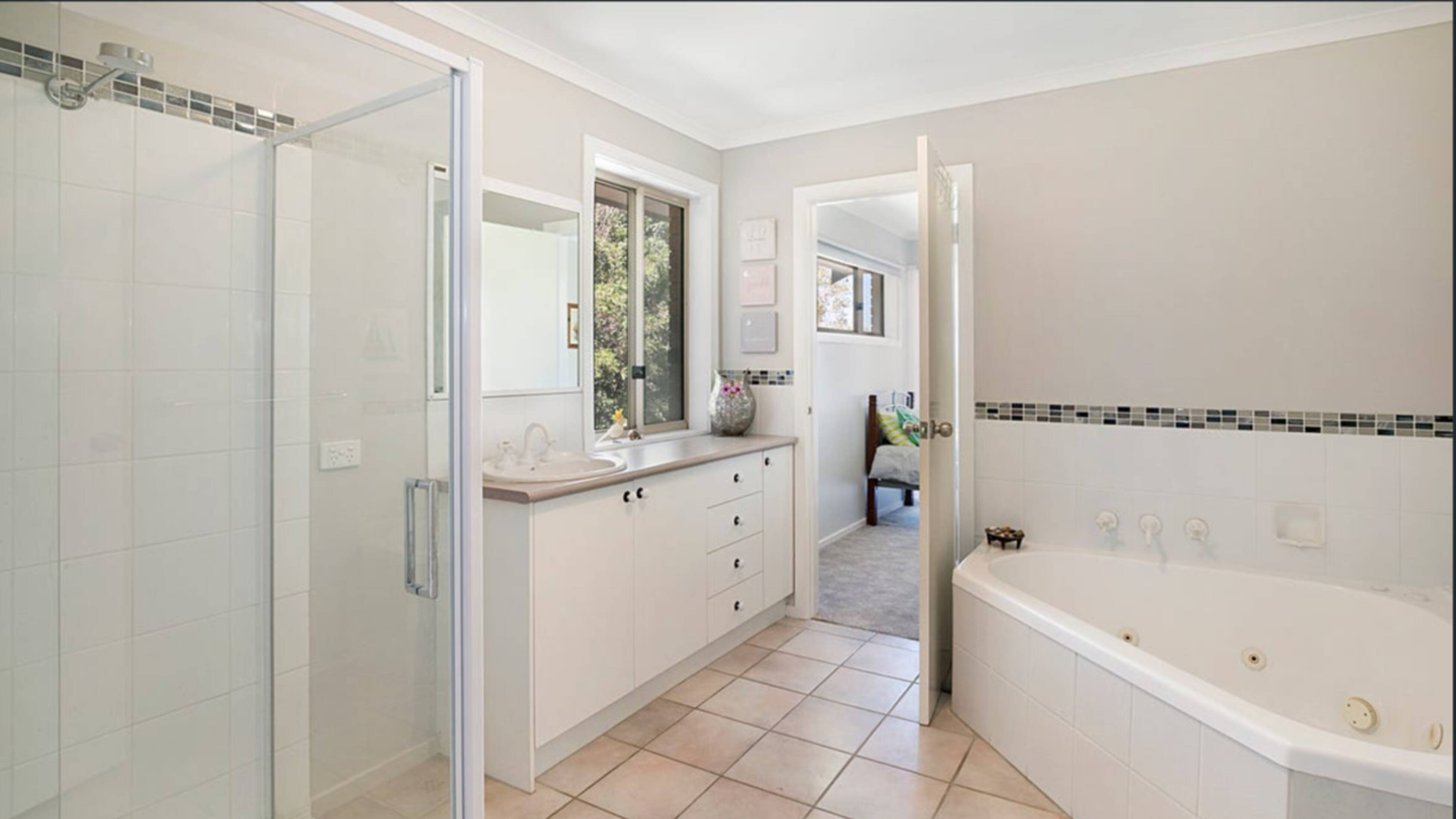 bathroom before image with old shower and vanity 