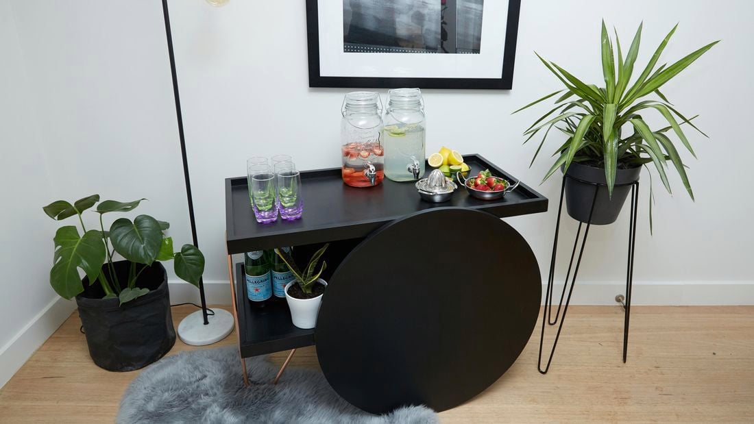 DIY bar cart with plants to the side.