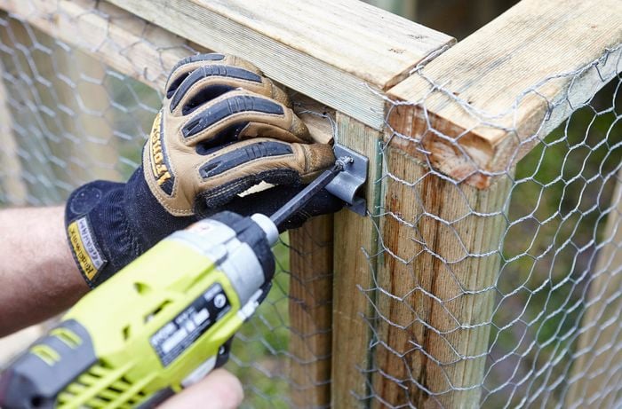 The latch for a simple slide lock being fitted to the outside of the chicken coop