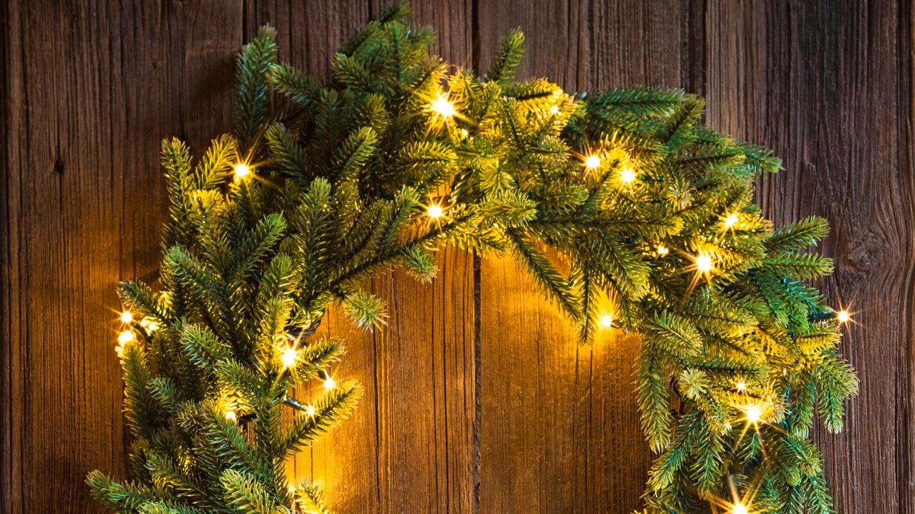 Christmas wreath on a timber front door with fairy lights